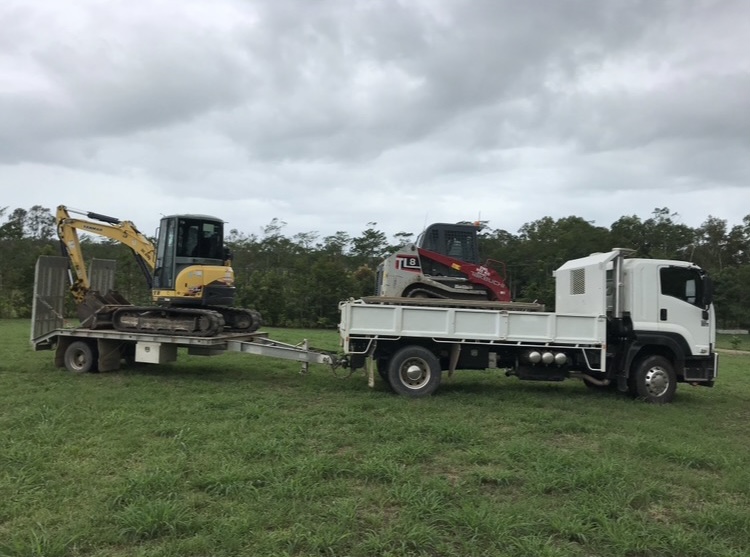 Tipper truck and plant float loaded with a mini excavator and a track loader, ready to mobilise